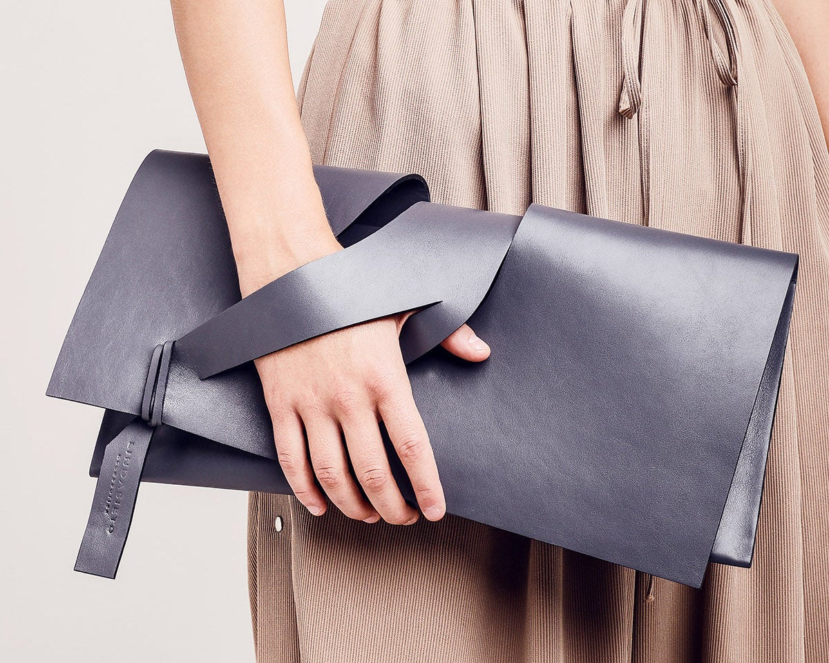 lindasieto magyar designer szürke bőr alkalmi boríték táska diagonal extra grey leather architectural, geometric clutch bag worn in hand unique wrist strap design