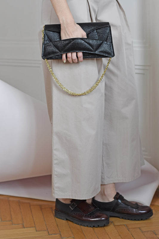 Handmade black Italian genuine leather, or vegan handbag, crossbody, oversize, soft clutch bag with unique wrist strap by Hungarian, Budapest based designer. Bőr designer válltáska, táska, magyar táskatervező márka.