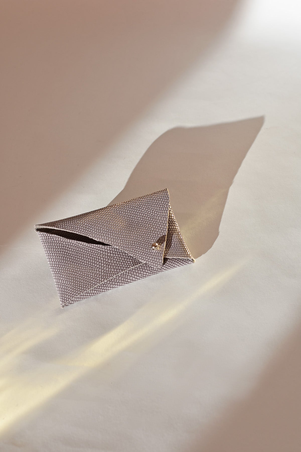 Womens mini and sleek leather cardholder wallet in embossed taupe, envelope style design. lilac.