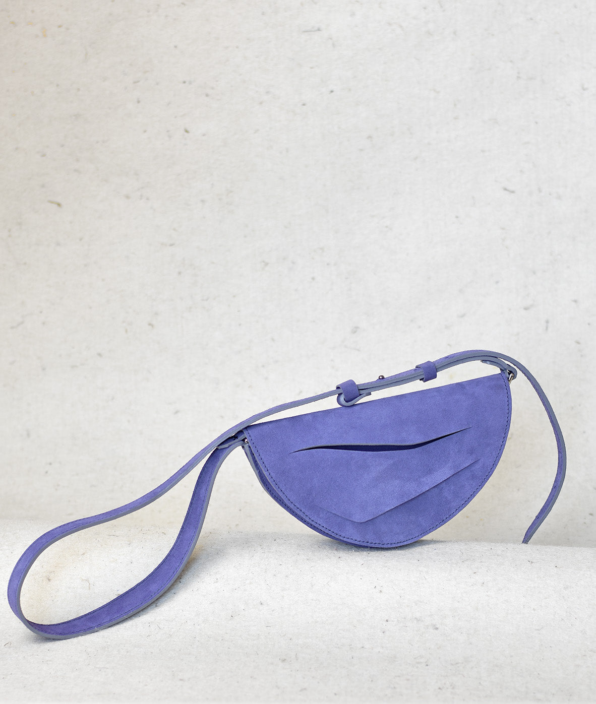 Handmade clutch bag crafted from genuine Italian suede leather, lilac amethyst handbag, crossbody purse with unique wrist strap by Hungarian, Budapest based designer. Lila hasítottbőr designer borítéktáska, táska, magyar tervező márka.