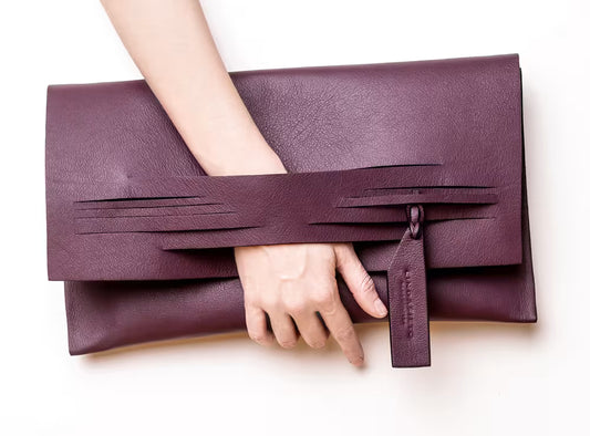 Modern, sculptural clutch bag handcrafted from premium Italian leather, dark red burgundy garnet wine red handbag, purse with unique wrist strap by Hungarian, Budapest based designer Lindasieto. Bordó választható színű bőr designer borítéktáska, táska, magyar tervezői márka.