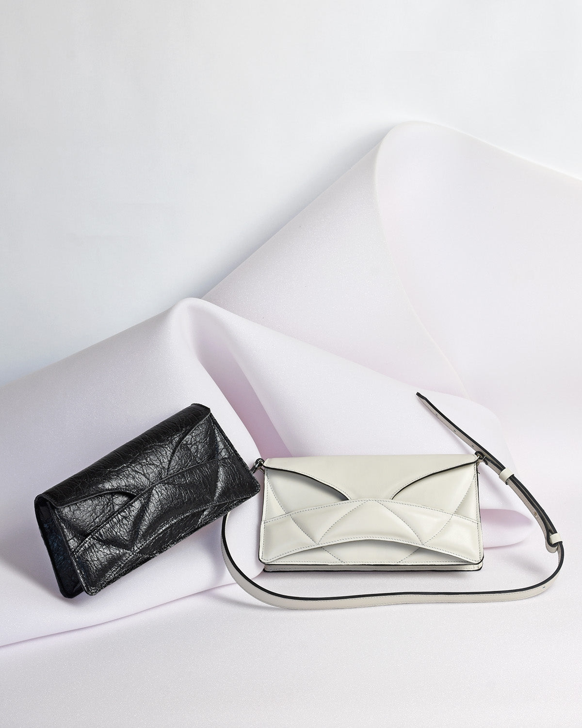 Handmade bridal, wedding clutch bag handcrafted from genuine Italian leather, or vegan custom colors, elegant, white handbag, crossbody purse with unique wrist strap by Hungarian, Budapest, EU based designer. Elegáns, fehér választható színű bőr designer borítéktáska, menyasszonyi táska, válltáska magyar táskatervező márka.