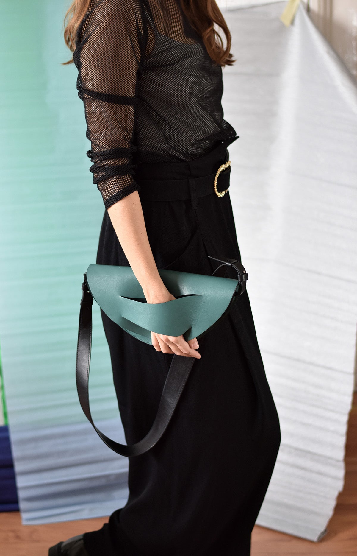 Handmade clutch bag handcrafted from genuine Italian leather, custom colors, black, green halfmoonbag crescent handbag, crossbody purse with unique wrist strap by Hungarian, Budapest based designer. Fekete, zöld, félhold választható színű bőr designer borítéktáska, táska, válltáska magyar táskatervező márka.
