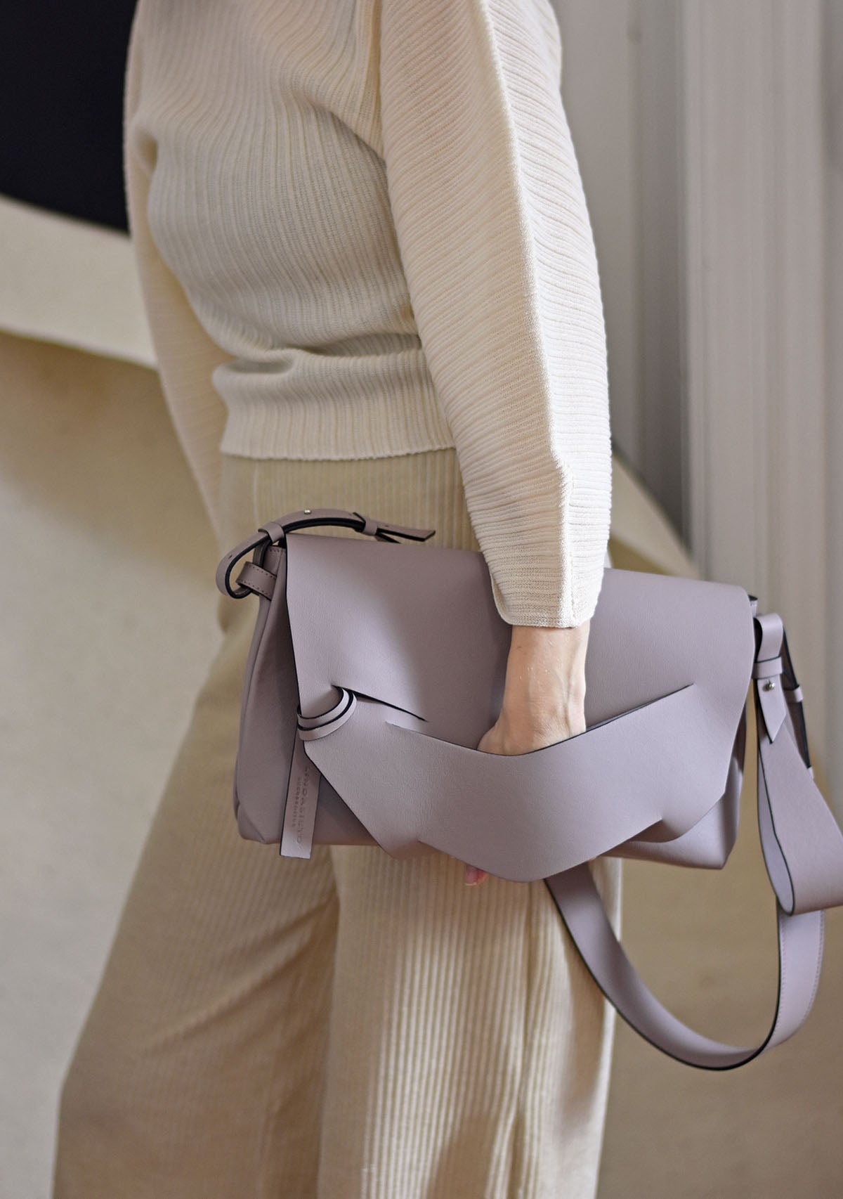 Handmade light taupe neutral Italian genuine leather handbag, crossbody clutch with unique wrist strap by Hungarian, Budapest based designer. Világos natúr taupe bőr designer válltáska, táska, magyar táskatervező márka.