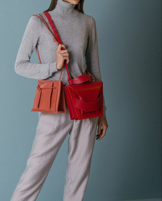 Lindasieto Layered Bag handcrafted from luxurious Italian red nappa leather, sculptural minimalist handbag, crossbody purse with unique wrist strap by Hungarian, Budapest based designer. Piros bőr kortárs designer válltáska magyar táska tervező márka.
