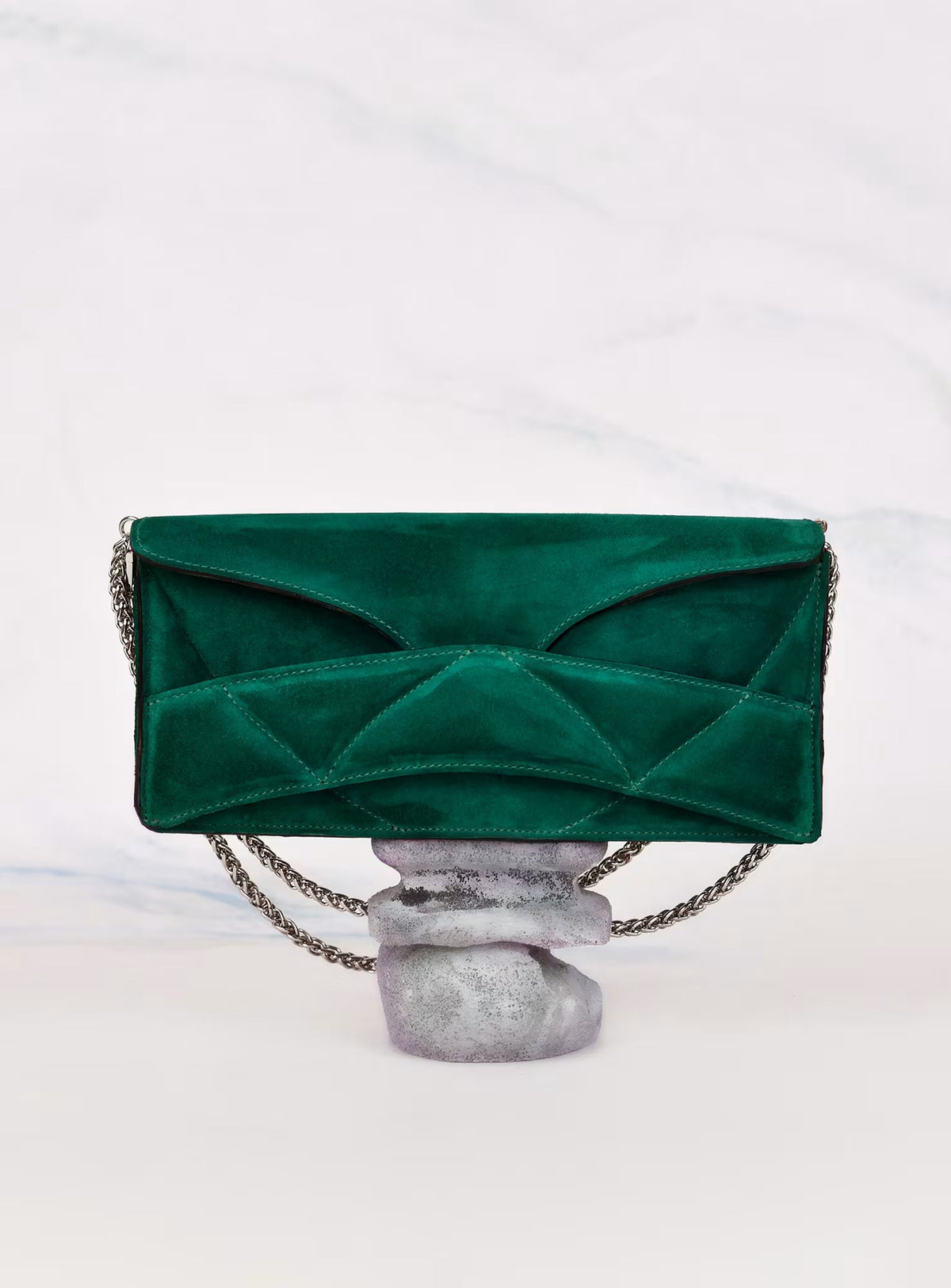 Lindasieto sculptural Abstract Heart Bag with silver chain strap in dark emerald green suede calf leather on pastel toned sculpted pedestal