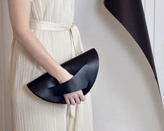 Fekete bőr magyar designer táska, válltáska, tervezői márka. Sculptural clutch bag, genuine Italian leather, custom colors, black handbag, crossbody purse with unique wrist strap by Hungarian, Budapest based designer. 