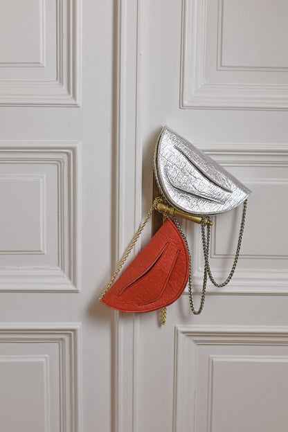 Handmade red silver vegan handbag, crossbody, clutch bag with unique wrist strap by Hungarian, Budapest based designer. Bőr designer válltáska, táska márka, magyar tervező.