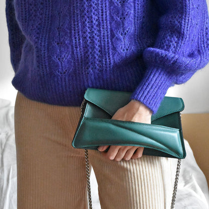 Jade green leather designer clutch to crossbody bag, purse worn in hand by unique wrist strap by Budapest based fashion brand. Egyedi magyar bőr borítéktáska, zöld női táska.