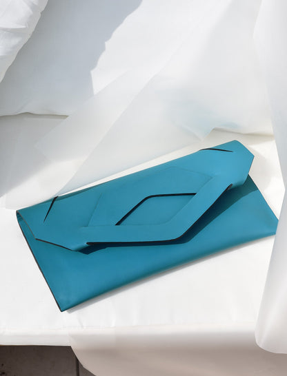 Lindasieto prémium, türkiz kék, alkalmi, valódi bőr Triangular Slashed designer clutch táska, magyar tervezői táska márka, monogrammal. Personalised, sculptural, teal blue Italian nappa leather, handmade elegant occasion clutch bag, unique wrist strap, wedding clutch gift, Budapest fashion brand.