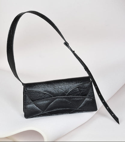 Avantgarde black Italian genuine leather, or vegan handbag, crossbody, oversize, soft clutch bag with unique wrist strap by Hungarian, Budapest based designer. Bőr designer válltáska, táska, magyar táskatervező márka.