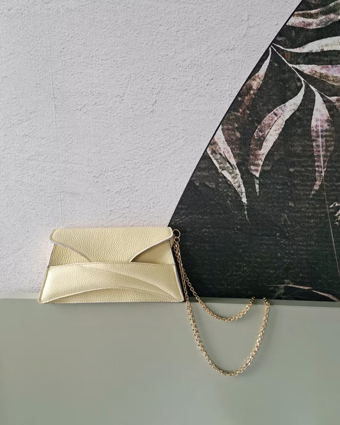 Butter pastel yellow textured, genuine leather designer clutch to crossbody bag, purse  with unique wrist strap, silver chain strap by Budapest based fashion brand. Egyedi, magyar valódi bőr táska, pasztell, vaj sárga női táska, ezüst lánc vállpánttal.