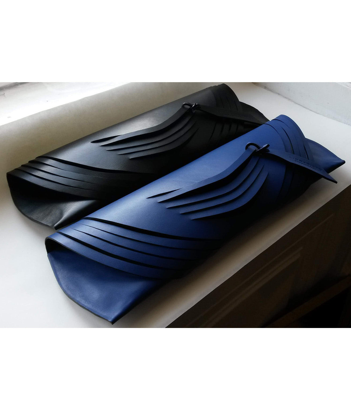 Lindasieto Curved Slashed Clutch bag crafted from black Italian leather, custom colors, sculptural, minimalist east west style purse with unique wrist strap by Budapest  independent designer. Fekete, választható színű bőr designer borítéktáska, táska, magyar táskatervező, magyar táska designer márka.