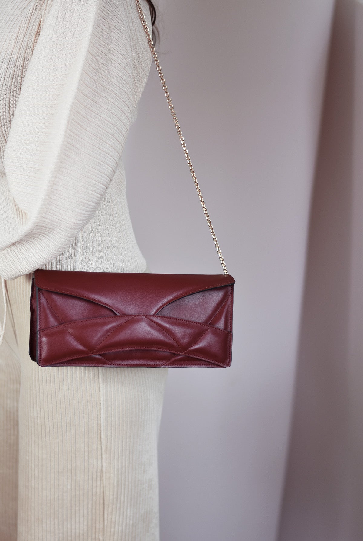 Lindasieto Abstract Heart Bag handcrafted from luxurious Italian dark red nappa leather, sculptural minimalist handbag, crossbody purse with unique wrist strap by Hungarian, Budapest based designer. Piros bordó bőr kortárs designer válltáska magyar táska tervező márka.