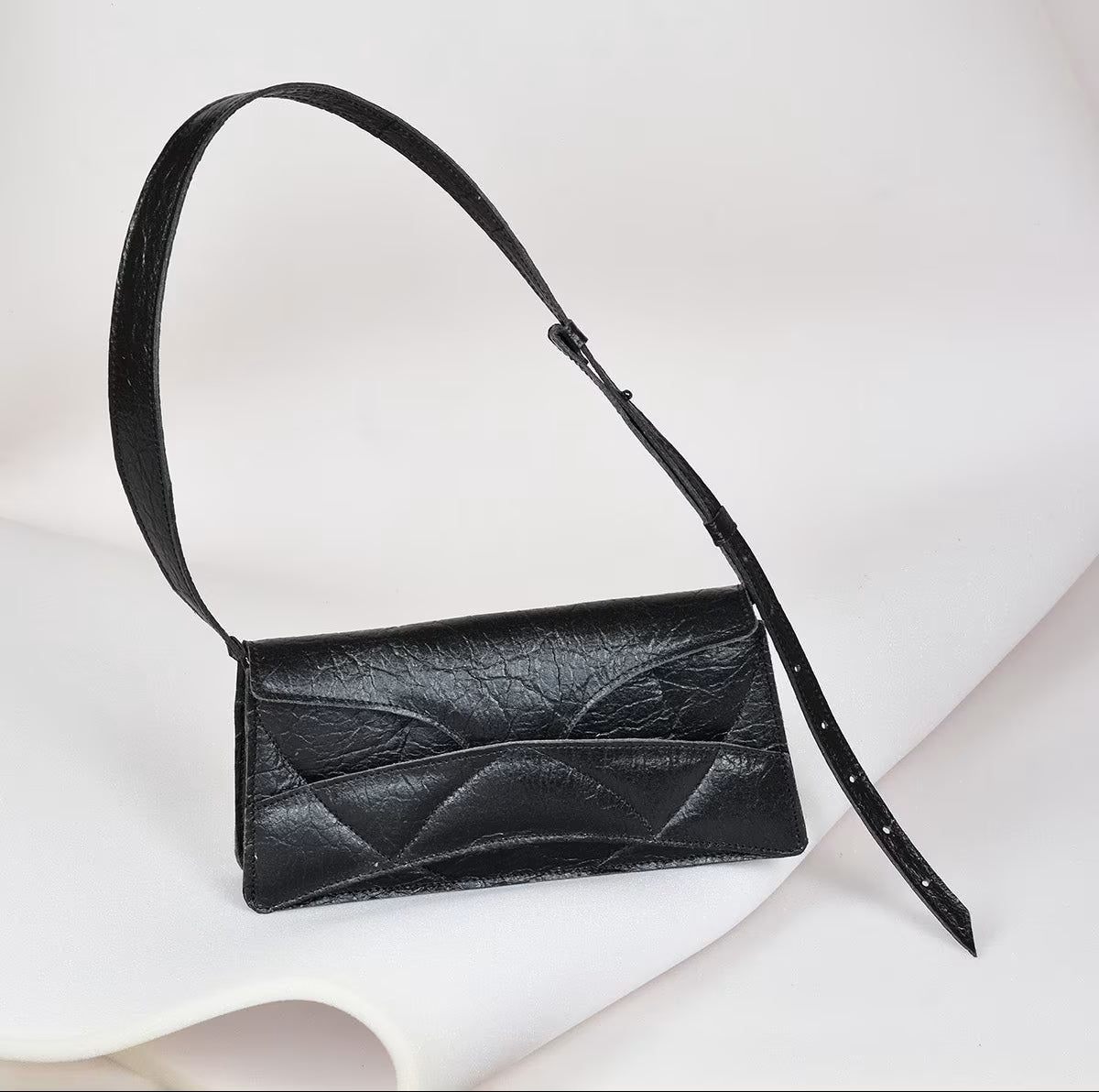 Avantgarde black Italian genuine leather, or vegan handbag, crossbody, oversize, soft clutch bag with unique wrist strap by Hungarian, Budapest based designer. Bőr designer válltáska, táska, magyar tervezői táskamárka.