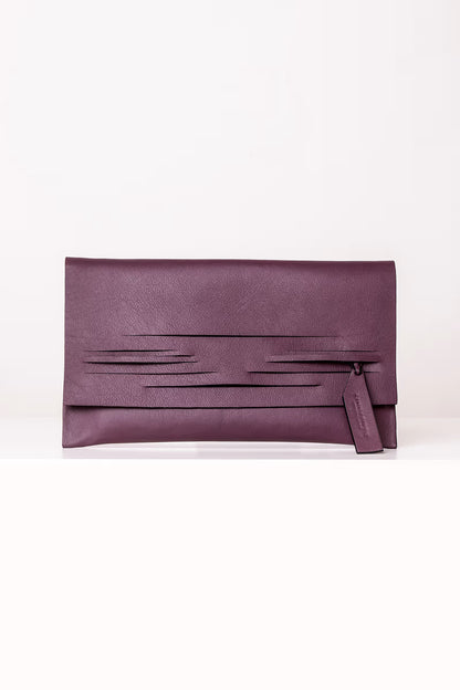 Sculptural, minimalist Horizontal Slashed clutch bag handcrafted from premium Italian leather, dark red burgundy garnet wine red handbag, purse with unique wrist strap by Hungarian, Budapest based designer Linda Sieto. Bordó választható színű bőr designer borítéktáska, táska, magyar tervezői márka.