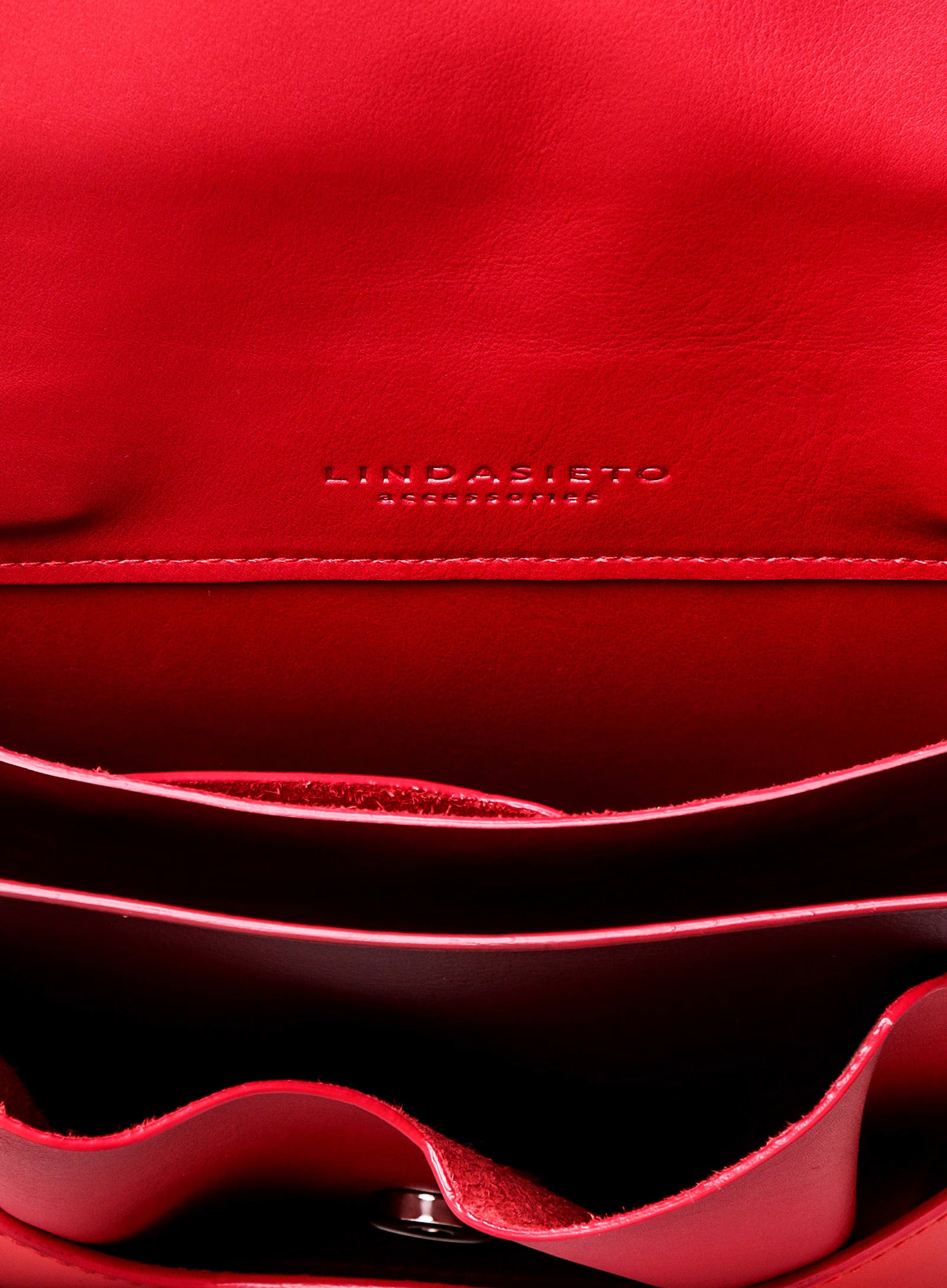 Close-up of red nappa sculptural leather Layered Bag with 'Lindasieto' branding, visible stitching and inner panels, pockets, handpainted edges, by Budapest based independent designer brand.