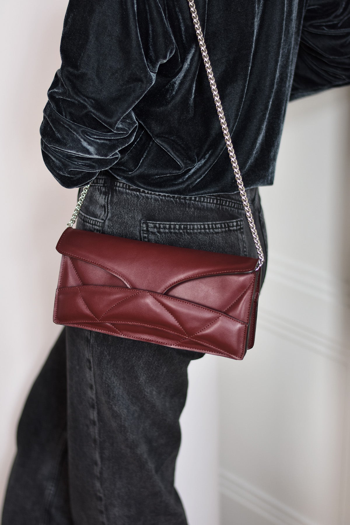 Lindasieto Abstract Heart Bag handcrafted from luxurious Italian dark red nappa leather, sculptural minimalist handbag, crossbody purse with unique wrist strap by Hungarian, Budapest based designer. Piros bordó bőr kortárs designer válltáska magyar táska tervező márka.