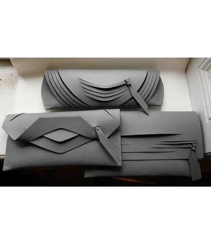 Handmade clutch bag handcrafted from genuine Italian leather, custom colors, black handbag, purse with unique wrist strap by Hungarian, Budapest based designer. Fekete, választható színű bőr designer borítéktáska, táska, magyar táskatervező márka.