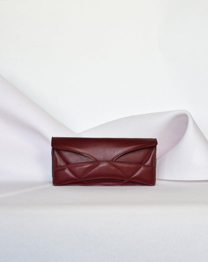 Lindasieto Abstract Heart Bag handcrafted from luxurious Italian dark red nappa leather, sculptural minimalist handbag, crossbody purse with unique wrist strap by Hungarian, Budapest based designer. Piros bordó bőr kortárs designer válltáska magyar táska tervező márka.