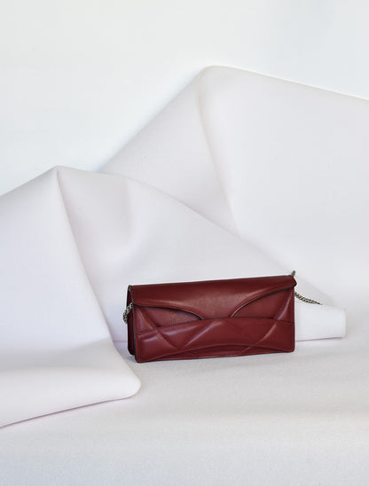 Lindasieto Abstract Heart Bag handcrafted from luxurious Italian dark red nappa leather, sculptural minimalist handbag, crossbody purse with unique wrist strap by Hungarian, Budapest based designer. Piros bordó bőr kortárs designer válltáska magyar táska tervező márka.