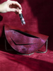 Video showing what fits inside a Lindasieto sculptural Mini Dune Bag, convertible clutch on chain with wrist strap in dark red, burgundy Italian leather. Limited numbers, custom colors, personalization, Budapest based designer. Lindasieto Mini Dune egyedi bordó bőr designer táska, magyar iparművész táska tervező,  prémium olasz bőrök, személyre szabott ajándék, monogram, magyar márka.