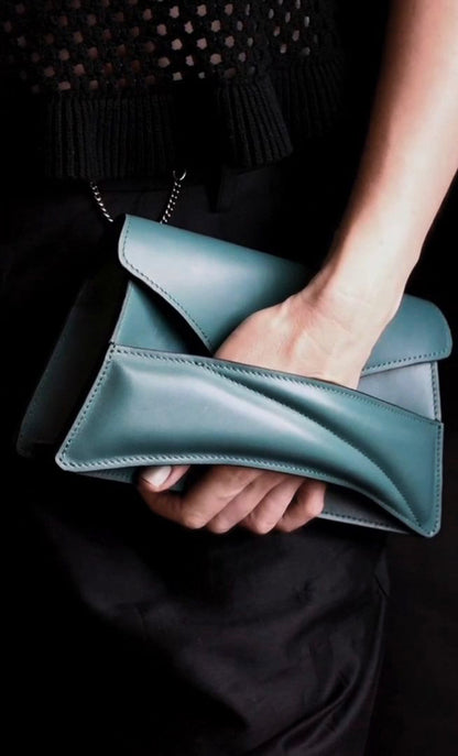 Lindasieto Link Bag, sculptural jade green leather clutch with a chain strap, close up detail of wrist strap and soft, green nappa leather texture. Magyar kortárs designer jade zöld bőr alkalmi női clutch táska, puha bőr csuklóőánt design és varrás részlete