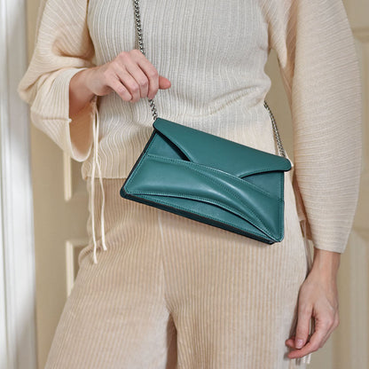 Jade emerald green leather minimalist clutch to crossbody bag, purse worn on the shoulder with unique wrist strap by Budapest based fashion brand. Egyedi designer magyar valódi bőr borítéktáska, zöld női táska.