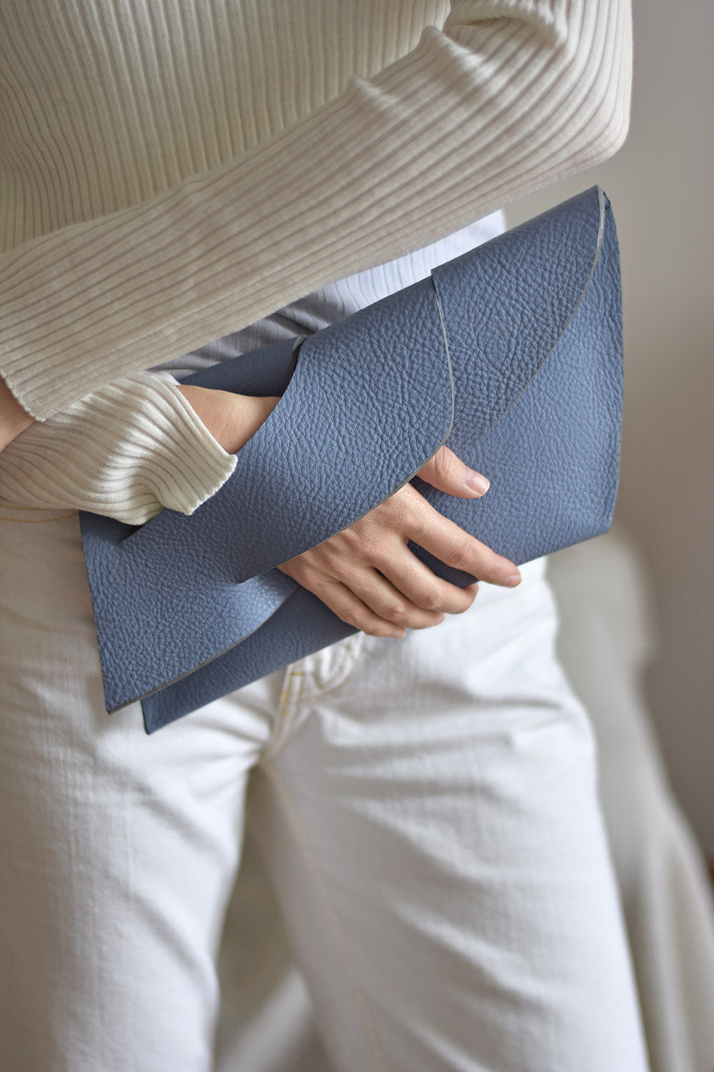 Handmade neutral grey blue genuine leather handbag, clutch purse with unique wrist strap by Hungarian, Budapest based designer.Bőr designer borítéktáska, magyar táskatervező márka.