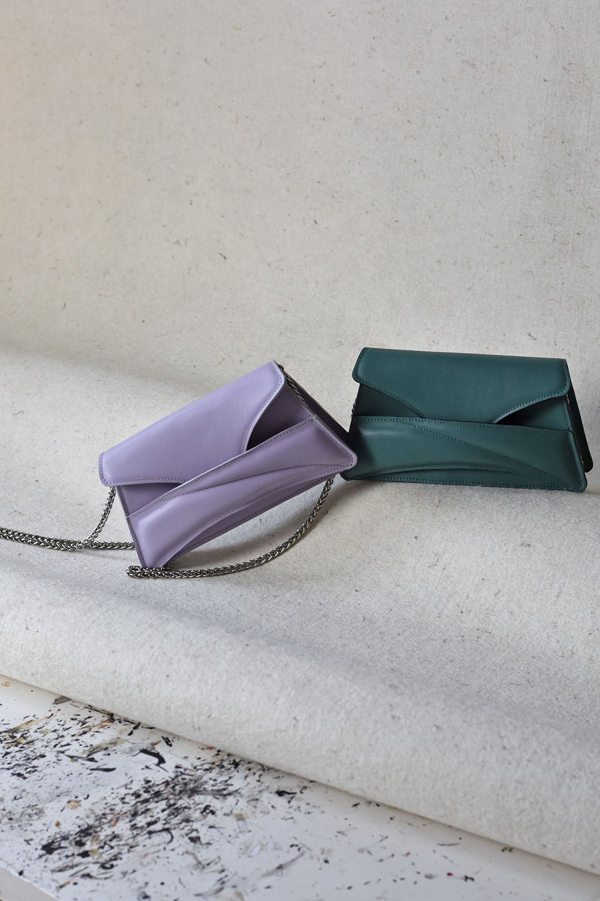 Lilac mauve leather designer clutch to crossbody bag, purse  with unique wrist strap, silver chain strap by Budapest based fashion brand. Egyedi magyar bőr borítéktáska, lila női táska, ezüst lánc vállpánttal.