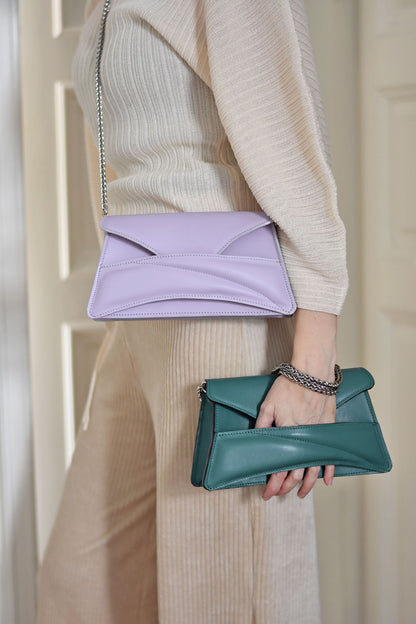 Lilac and jade green leather designer clutch to crossbody bag, purse  with unique wrist strap, silver chain strap by Budapest based fashion brand. Egyedi magyar bőr borítéktáska, lila, zöld női táska, ezüst lánc vállpánttal.