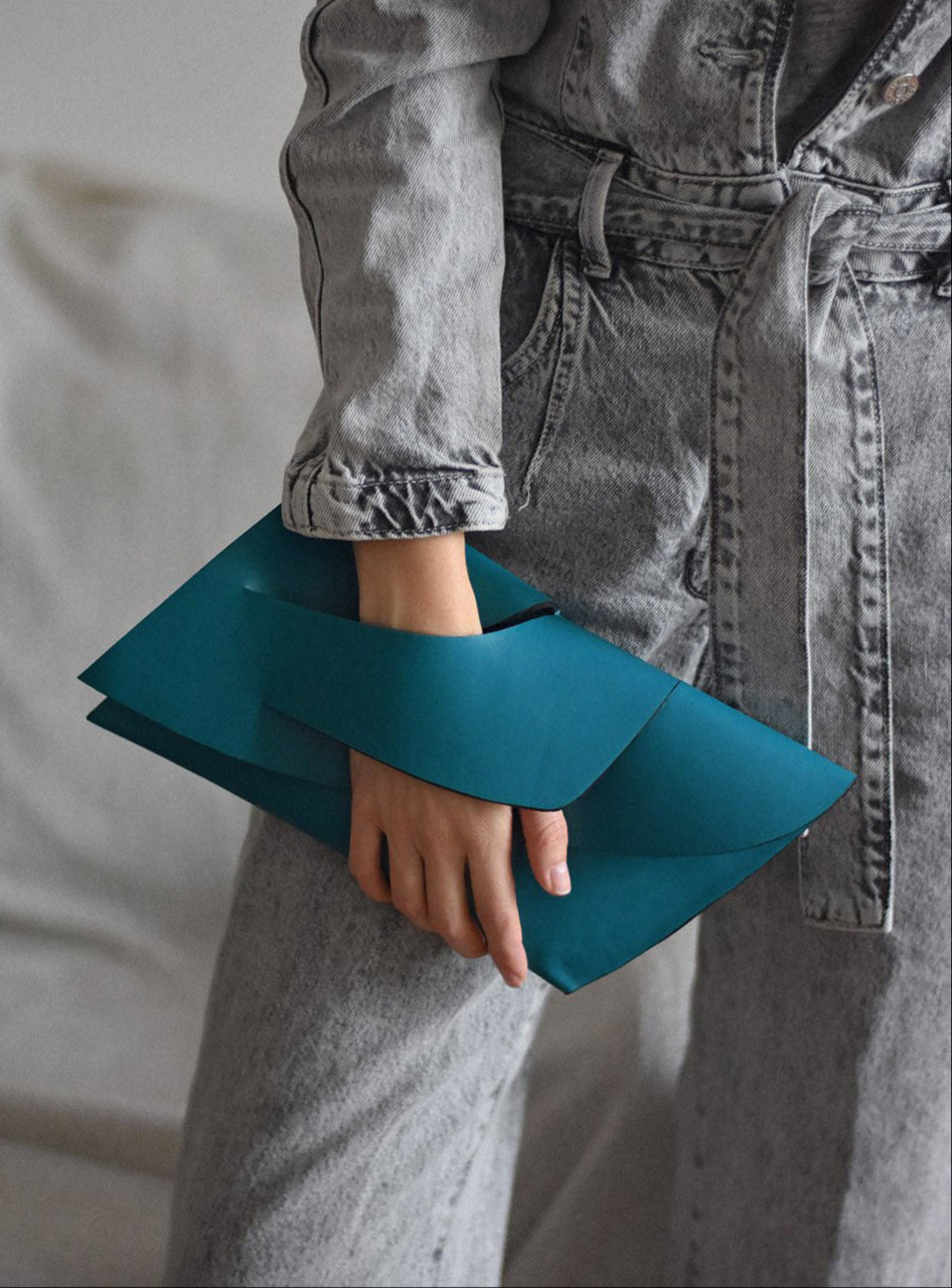 Handmade teal green blue genuine leather handbag, clutch purse with unique wrist strap by Hungarian, Budapest based designer. Bőr designer borítéktáska, magyar táskatervező márka.