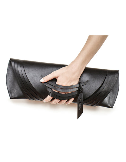 Lindasieto Curved Slashed Clutch bag crafted from black Italian leather, custom colors, sculptural, minimalist east west style purse with unique wrist strap by Budapest  independent designer. Fekete, választható színű bőr designer borítéktáska, táska, magyar táskatervező, magyar táska designer márka.