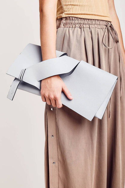 Handmade bridal clutch bag handcrafted from genuine Italian leather, custom colors, black, white handbag, purse with unique wrist strap by Hungarian, Budapest, EU based designer. Fehér, választható színű bőr designer borítéktáska, esküvő, menyasszony táska, magyar táskatervező márka.